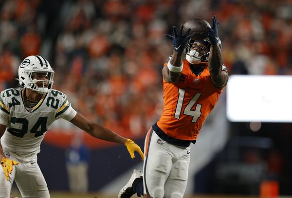 Dec 14, 2025; Denver, Colorado, USA; Denver Broncos wide receiver Courtland Sutton (14) catches a pass under pressure from Green Bay Packers cornerback Carrington Valentine (24) during the fourth quarter at Empower Field at Mile High. Mandatory Credit: Isaiah J. Downing-Imagn Images