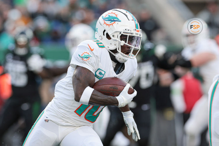 Nov 24, 2023; East Rutherford, New Jersey, USA; Miami Dolphins wide receiver Tyreek Hill (10) carries the ball during the first half against the New York Jets at MetLife Stadium. Credit: Vincent Carchietta-USA TODAY Sports