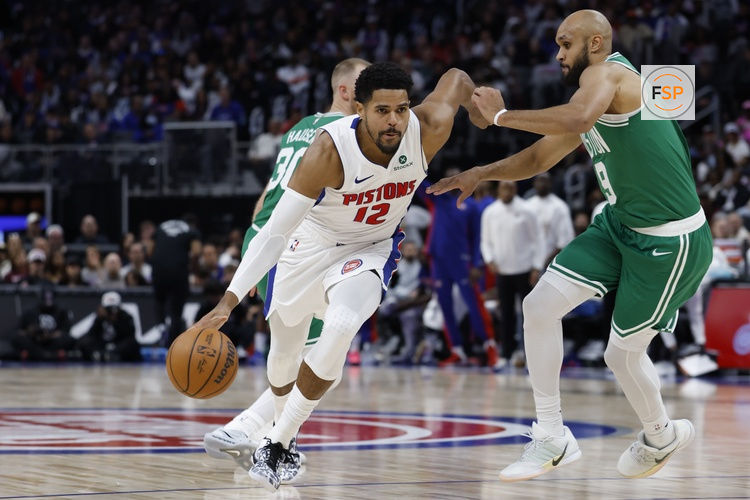 Oct 26, 2025; Detroit, Michigan, USA;  Detroit Pistons forward Tobias Harris (12) dribbles defended by Boston Celtics guard Derrick White (9) in the second half at Little Caesars Arena. Credit: Rick Osentoski-Imagn Images