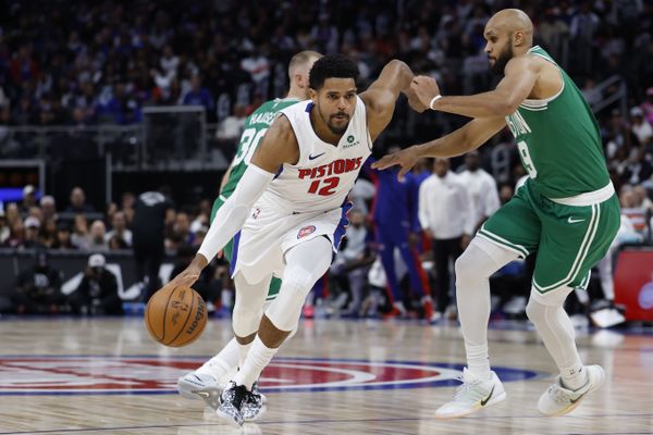 Oct 26, 2025; Detroit, Michigan, USA;  Detroit Pistons forward Tobias Harris (12) dribbles defended by Boston Celtics guard Derrick White (9) in the second half at Little Caesars Arena. Mandatory Credit: Rick Osentoski-Imagn Images