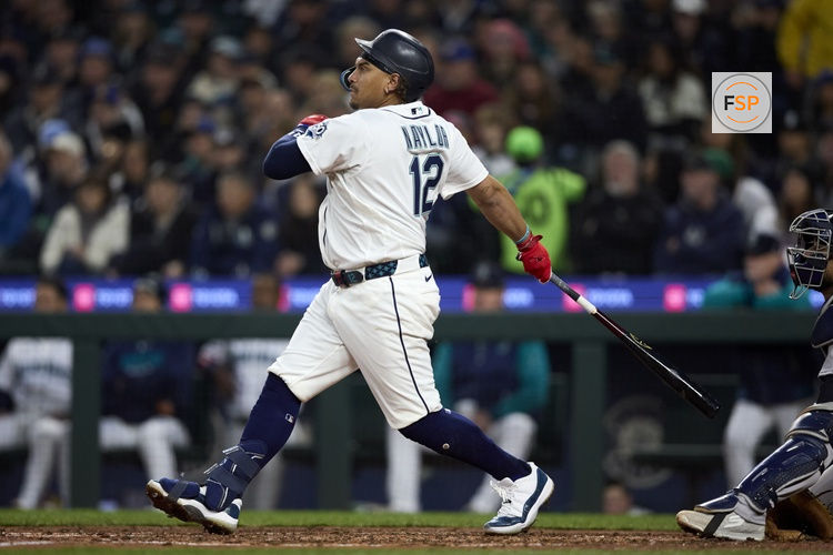 Mar 31, 2026; Seattle, Washington, USA; Seattle Mariners first baseman Josh Naylor (12) singles against the New York Yankees during the fourth inning at T-Mobile Park. Credit: John Froschauer-Imagn Images