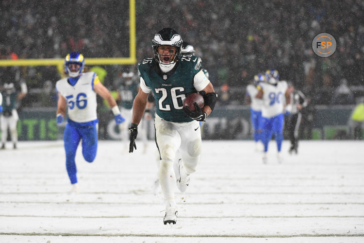 Jan 19, 2025; Philadelphia, Pennsylvania, USA; Philadelphia Eagles running back Saquon Barkley (26) carries the ball to score a touchdown against the Los Angeles Rams in the second half in a 2025 NFC divisional round game at Lincoln Financial Field. Credit: Eric Hartline-Imagn Images