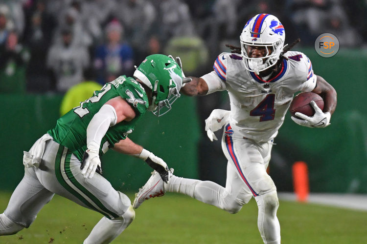 Nov 26, 2023; Philadelphia, Pennsylvania, USA; Buffalo Bills running back James Cook (4) stiff arms Philadelphia Eagles safety Reed Blankenship (32) at Lincoln Financial Field. Credit: Eric Hartline-USA TODAY Sports