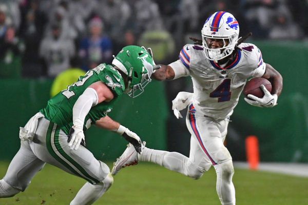 Nov 26, 2023; Philadelphia, Pennsylvania, USA; Buffalo Bills running back James Cook (4) stiff arms Philadelphia Eagles safety Reed Blankenship (32) at Lincoln Financial Field. Mandatory Credit: Eric Hartline-USA TODAY Sports