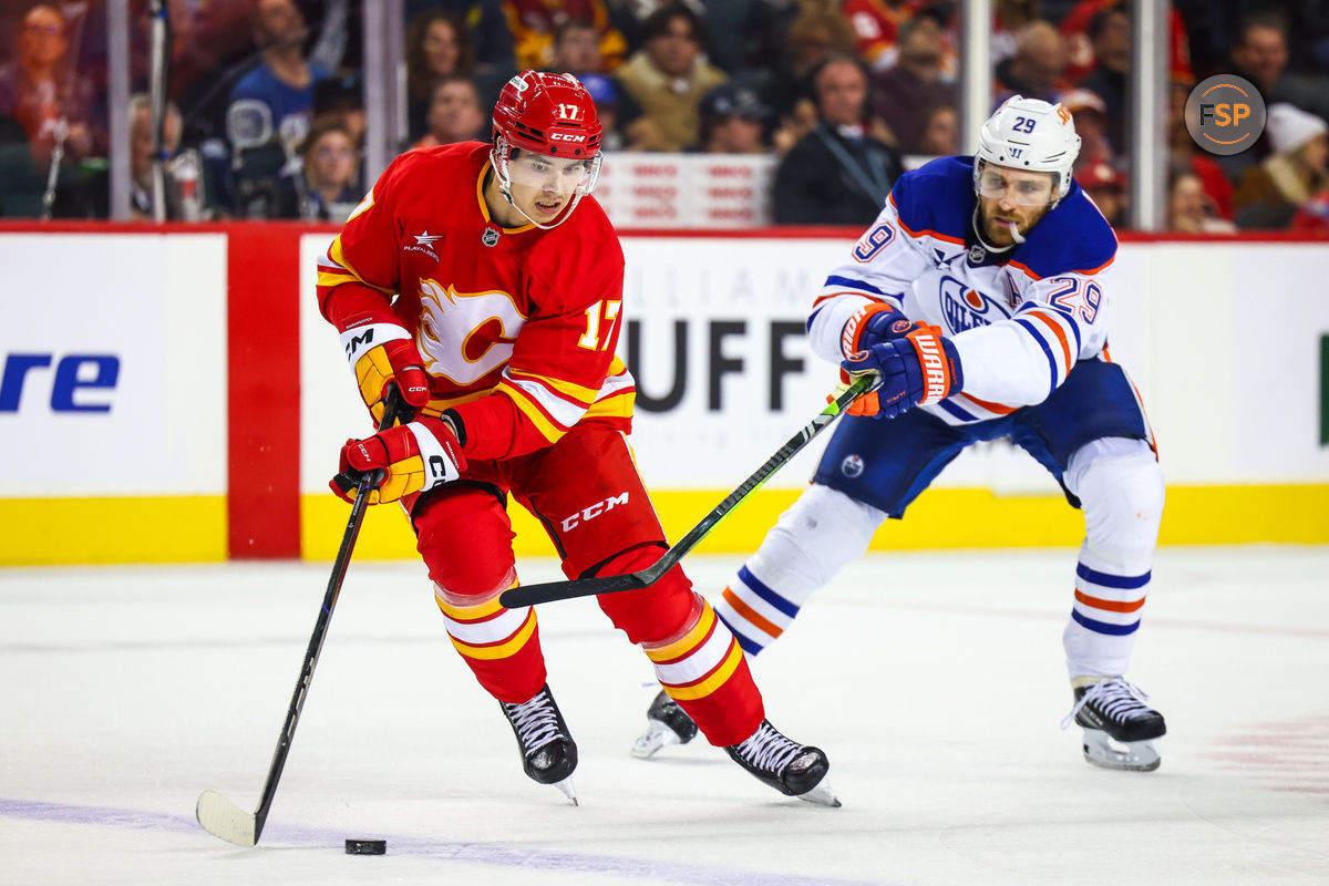 Nov 3, 2024; Calgary, Alberta, CAN; Calgary Flames center Yegor Sharangovich (17) and Edmonton Oilers center Leon Draisaitl (29) battles for the puck during the third period at Scotiabank Saddledome. Credit: Sergei Belski-Imagn Images