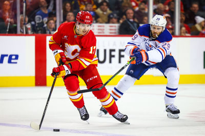 Nov 3, 2024; Calgary, Alberta, CAN; Calgary Flames center Yegor Sharangovich (17) and Edmonton Oilers center Leon Draisaitl (29) battles for the puck during the third period at Scotiabank Saddledome. Mandatory Credit: Sergei Belski-Imagn Images