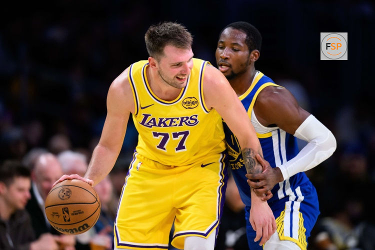 Oct 21, 2025; Los Angeles, California, USA; Los Angeles Lakers guard Luka Doncic (77) looks to drive against Golden State Warriors forward Jonathan Kuminga (1) during the second half at Crypto.com Arena. Credit: William Liang-Imagn Images