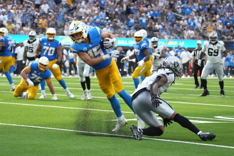 Sep 8, 2024; Inglewood, California, USA; Los Angeles Chargers wide receiver Ladd McConkey (15) scores on a 15-yard touchdown reception against Las Vegas Raiders safety Tre'von Moehrig (7) in the second half at SoFi Stadium. Credit: Kirby Lee-Imagn Images