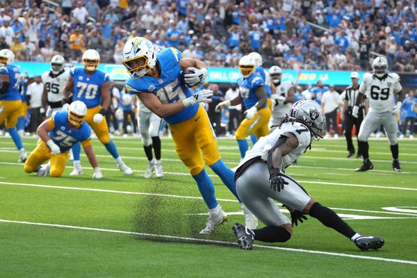 Sep 8, 2024; Inglewood, California, USA; Los Angeles Chargers wide receiver Ladd McConkey (15) scores on a 15-yard touchdown reception against Las Vegas Raiders safety Tre'von Moehrig (7) in the second half at SoFi Stadium. Mandatory Credit: Kirby Lee-Imagn Images