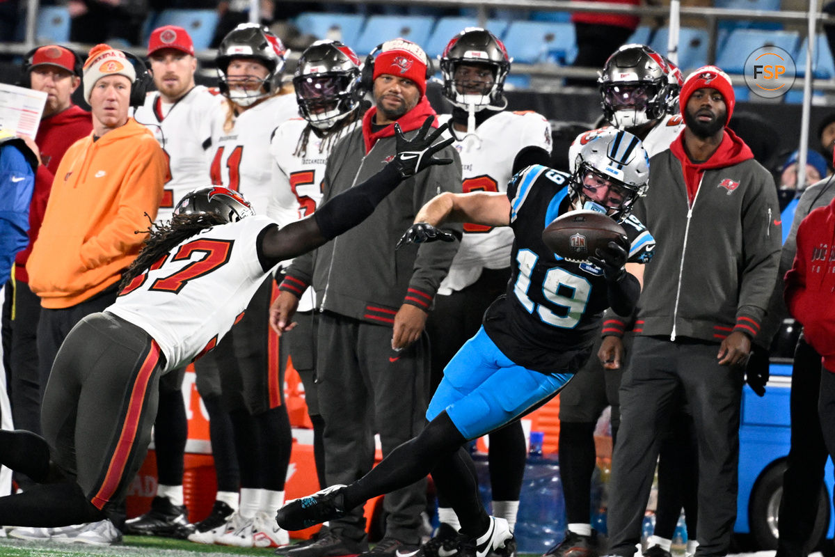 Dec 1, 2024; Charlotte, North Carolina, USA;  Carolina Panthers wide receiver Adam Thielen (19) makes a one handed catch as /Tampa Bay Buccaneers cornerback Tavierre Thomas (37) defends in overtime at Bank of America Stadium. Credit: Bob Donnan-Imagn Images