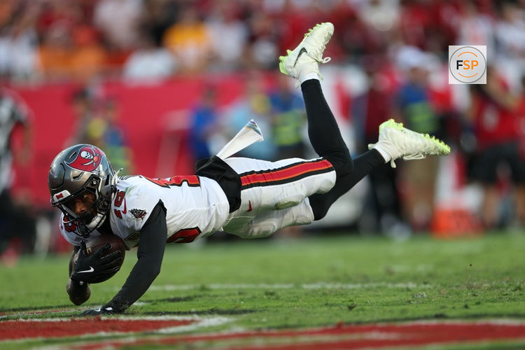 Oct 12, 2025; Tampa, Florida, USA; Tampa Bay Buccaneers wide receiver Tez Johnson (15) dives for a touchdown during the third quarter against the San Francisco 49ers at Raymond James Stadium. Credit: Nathan Ray Seebeck-Imagn Images