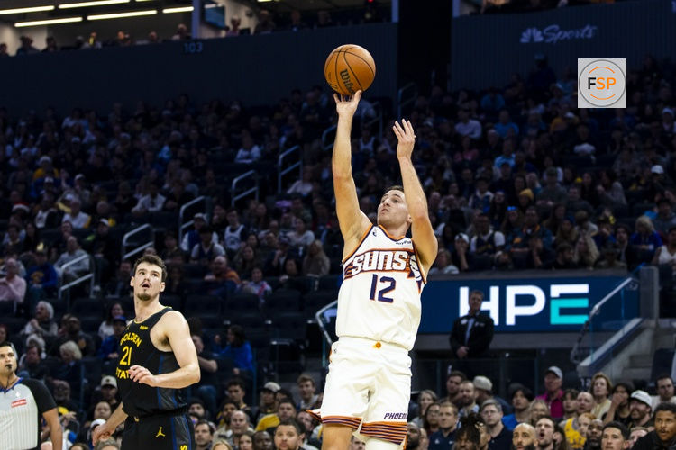 Dec 20, 2025; San Francisco, California, USA; Golden State Warriors center Quinten Post (21) watches as Phoenix Suns guard Collin Gillespie (12) takes a three-point shot during the second quarter at Chase Center. Credit: John Hefti-Imagn Images
