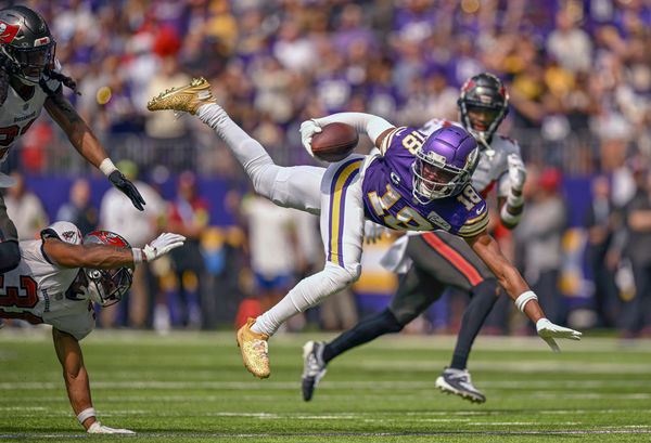 MINNEAPOLIS, MN - SEPTEMBER 10: Minnesota Vikings wide receiver Justin Jefferson (18) is tripped up by Tampa Bay Buccaneers defensive back Antoine Winfield Jr. (31) during an NFL game between the Minnesota Vikings and Tampa Bay Buccaneers  on September 10, 2023, at U.S. Bank Stadium in Minneapolis, MN. (Photo by Nick Wosika/Icon Sportswire)