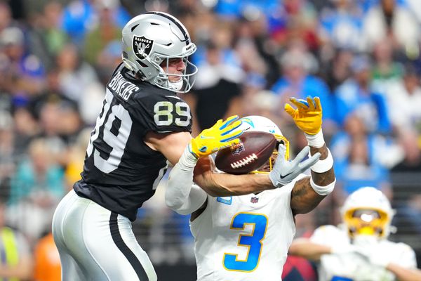 Jan 5, 2025; Paradise, Nevada, USA; Las Vegas Raiders tight end Brock Bowers (89) and Los Angeles Chargers safety Derwin James Jr. (3) reach for a pass during the fourth quarter at Allegiant Stadium. Mandatory Credit: Stephen R. Sylvanie-Imagn Images