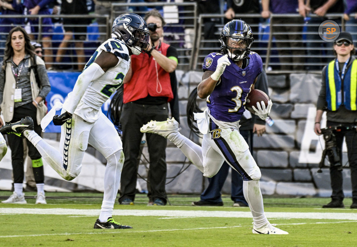 BALTIMORE, MD - NOVEMBER 05:  Baltimore Ravens running back Keaton Mitchell (34) runs for a touchdown  against Seattle Seahawks cornerback Riq Woolen (27) during the Seattle Seahawks game versus the Baltimore Ravens on November 5, 2023 at M&T Bank Stadium in Baltimore, MD.  (Photo by Mark Goldman/Icon Sportswire)