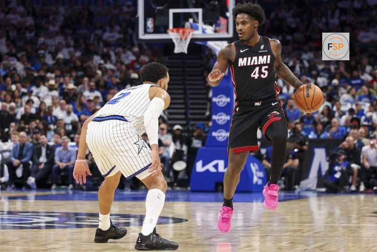 Oct 22, 2025; Orlando, Florida, USA; Miami Heat guard Davion Mitchell (45) controls the ball guarded by Orlando Magic guard Tyus Jones (2) in the second quarter at Kia Center. Credit: Nathan Ray Seebeck-Imagn Images