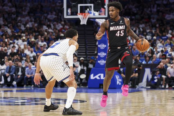Oct 22, 2025; Orlando, Florida, USA; Miami Heat guard Davion Mitchell (45) controls the ball guarded by Orlando Magic guard Tyus Jones (2) in the second quarter at Kia Center. Mandatory Credit: Nathan Ray Seebeck-Imagn Images