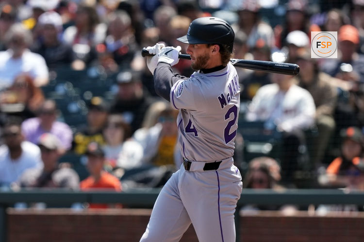 May 3, 2025; San Francisco, California, USA; Colorado Rockies third baseman Ryan McMahon (24) hits an RBI single against the San Francisco Giants during the sixth inning at Oracle Park. Credit: Darren Yamashita-Imagn Images