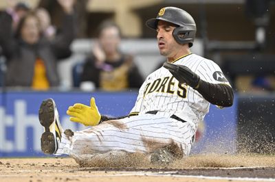 Apr 27, 2026; San Diego, California, USA; San Diego Padres right fielder Ramon Laureano (5) slides as he scores during the first inning against the Chicago Cubs at Petco Park. Mandatory Credit: Denis Poroy-Imagn Images