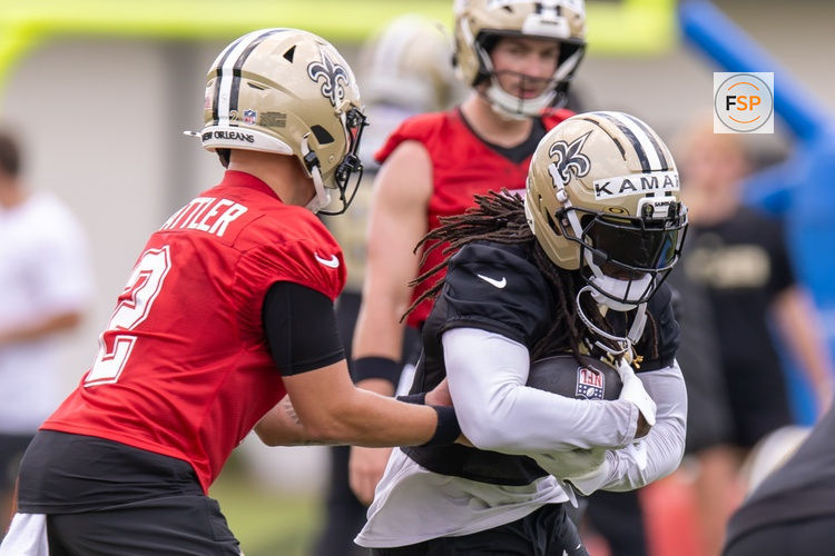 Jun 10, 2025; New Orleans, LA, USA;  New Orleans Saints quarterback Spencer Rattler (2) hands the ball off to running back Alvin Kamara (41) during minicamp at Ochsner Sports Performance Center. Credit: Stephen Lew-Imagn Images