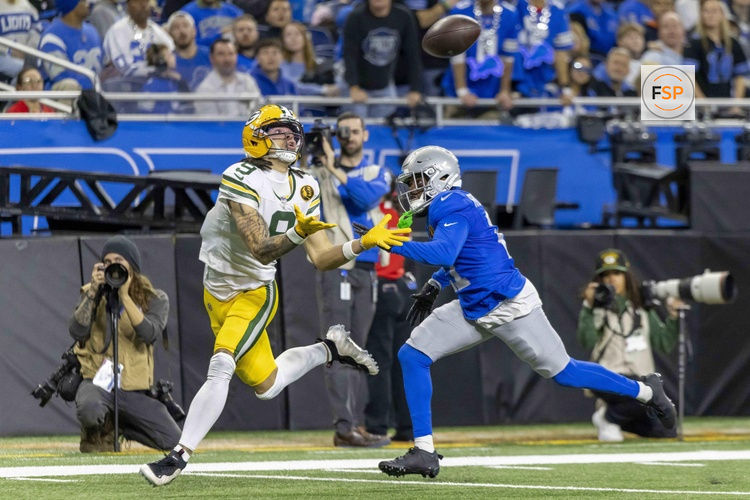 Nov 27, 2025; Detroit, Michigan, USA; Green Bay Packers wide receiver Christian Watson (9) catches a pass against Detroit Lions cornerback Amik Robertson (21) during the third quarter at Ford Field. Credit: David Reginek-Imagn Images