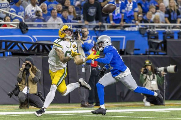 Nov 27, 2025; Detroit, Michigan, USA; Green Bay Packers wide receiver Christian Watson (9) catches a pass against Detroit Lions cornerback Amik Robertson (21) during the third quarter at Ford Field. Mandatory Credit: David Reginek-Imagn Images