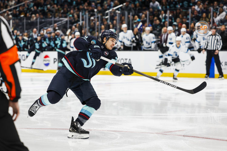 Dec 30, 2024; Seattle, Washington, USA; Seattle Kraken center Yanni Gourde (37) shoots the puck against the Utah Hockey Club during the third period at Climate Pledge Arena. Credit: Joe Nicholson-Imagn Images