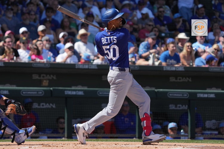 Mar 15, 2026; Mesa, Arizona, USA; Los Angeles Dodgers shortstop Mookie Betts (50) hits against  the Chicago Cubs in the first inning at Sloan Park. Credit: Rick Scuteri-Imagn Images