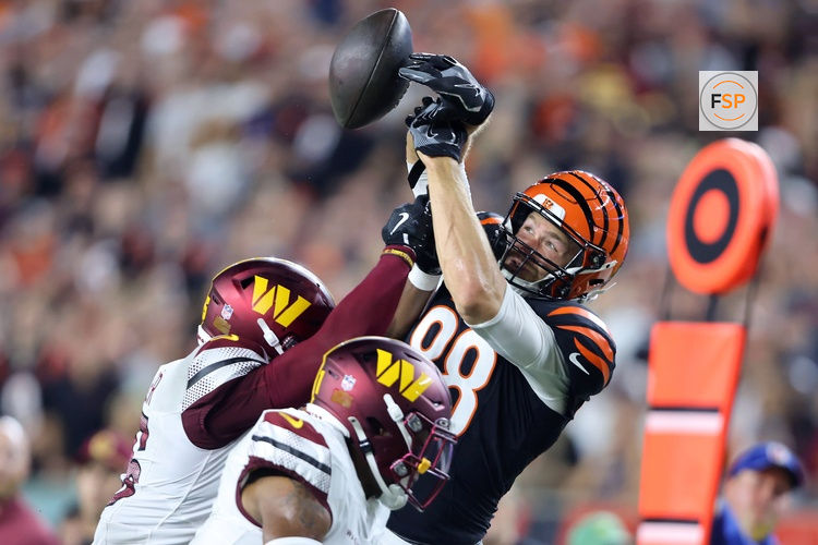 Sep 23, 2024; Cincinnati, Ohio, USA; Cincinnati Bengals tight end Mike Gesicki (88) has the ball knocked out by Washington Commanders safety Percy Butler (35) during the second quarter at Paycor Stadium. Credit: Joseph Maiorana-Imagn Images