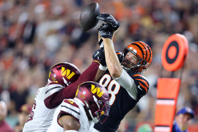 Sep 23, 2024; Cincinnati, Ohio, USA; Cincinnati Bengals tight end Mike Gesicki (88) has the ball knocked out by Washington Commanders safety Percy Butler (35) during the second quarter at Paycor Stadium. Mandatory Credit: Joseph Maiorana-Imagn Images