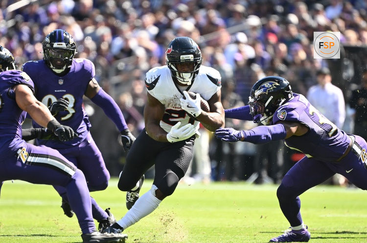 Oct 5, 2025; Baltimore, Maryland, USA; Houston Texans running back Woody Marks (27) runs for a gain past Baltimore Ravens linebacker Trenton Simpson (32) during the first quarter at M&T Bank Stadium. Credit: Rafael Suanes-Imagn Images