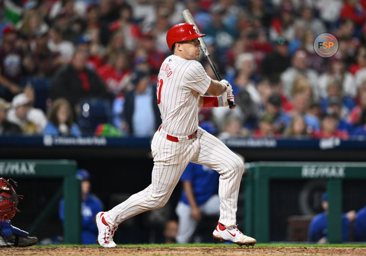 Sep 25, 2024; Philadelphia, Pennsylvania, USA; Philadelphia Phillies catcher J.T. Realmuto (10) hits an RBI single against the Chicago Cubs in the seventh inning at Citizens Bank Park. Credit: Kyle Ross-Imagn Images