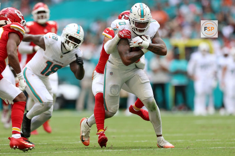 Sep 27, 2026; Miami Gardens, Florida, USA;  Miami Dolphins running back Ollie Gordon II (0) runs with the ball against Kansas City Chiefs safety Alohi Gilman (17) during the third quarter at Hard Rock Stadium.  Credit: Nathan Ray Seebeck-Imagn Images