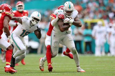 Sep 27, 2026; Miami Gardens, Florida, USA;  Miami Dolphins running back Ollie Gordon II (0) runs with the ball against Kansas City Chiefs safety Alohi Gilman (17) during the third quarter at Hard Rock Stadium.  Mandatory Credit: Nathan Ray Seebeck-Imagn Images