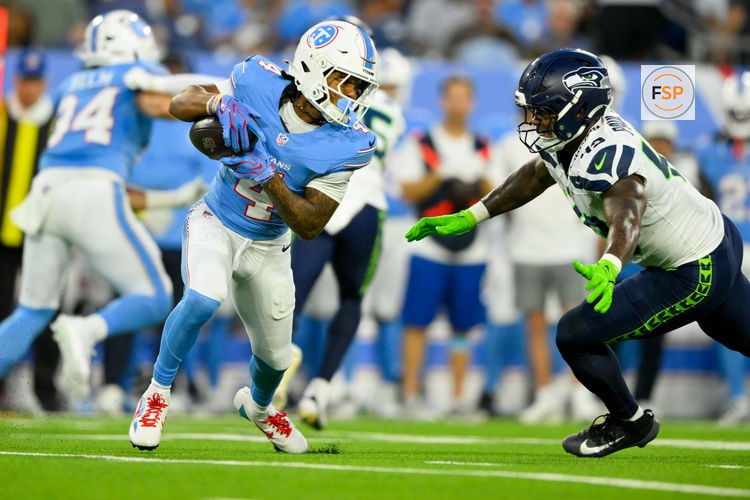 Aug 23, 2026; Nashville, Tennessee, USA;  Seattle Seahawks linebacker Chris Paul Jr. (49) tackles Tennessee Titans wide receiver Wan'Dale Robinson (4) after a made catch during the first half at Nissan Stadium. Credit: Steve Roberts-Imagn Images