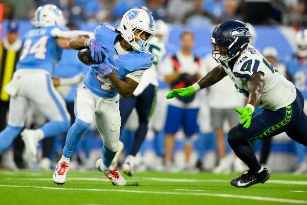 Aug 23, 2026; Nashville, Tennessee, USA;  Seattle Seahawks linebacker Chris Paul Jr. (49) tackles Tennessee Titans wide receiver Wan'Dale Robinson (4) after a made catch during the first half at Nissan Stadium. Mandatory Credit: Steve Roberts-Imagn Images