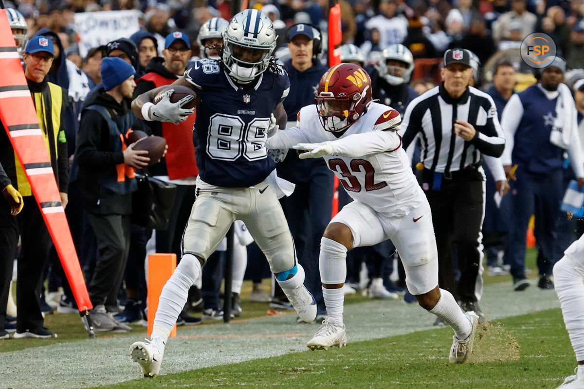 Jan 7, 2024; Landover, Maryland, USA; Dallas Cowboys wide receiver CeeDee Lamb (88) is pushed out of bounds after making a catch by Washington Commanders safety Terrell Burgess (32) during the first quarter at FedExField. Mandatory Credit: Geoff Burke-USA TODAY Sports