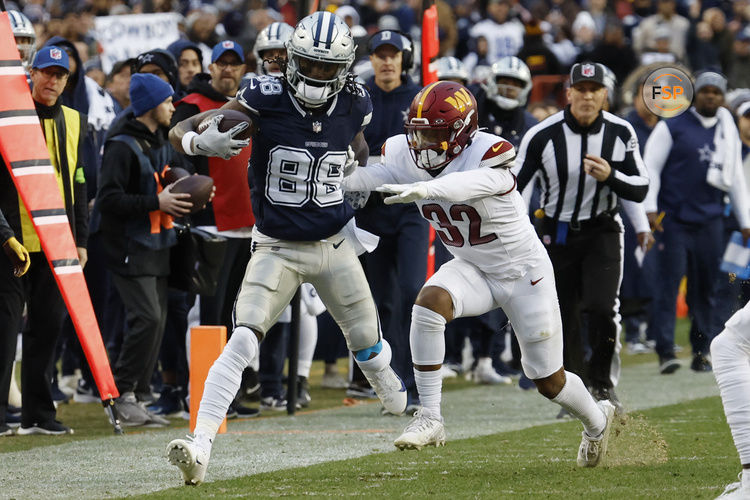 Jan 7, 2024; Landover, Maryland, USA; Dallas Cowboys wide receiver CeeDee Lamb (88) is pushed out of bounds after making a catch by Washington Commanders safety Terrell Burgess (32) during the first quarter at FedExField. Mandatory Credit: Geoff Burke-USA TODAY Sports