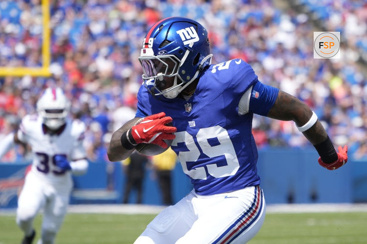 Aug 9, 2025; Orchard Park, New York, USA; New York Giants running back Tyrone Tracy Jr. (29) runs with the ball against the Buffalo Bills during the first half at Highmark Stadium. Credit: Gregory Fisher-Imagn Images
