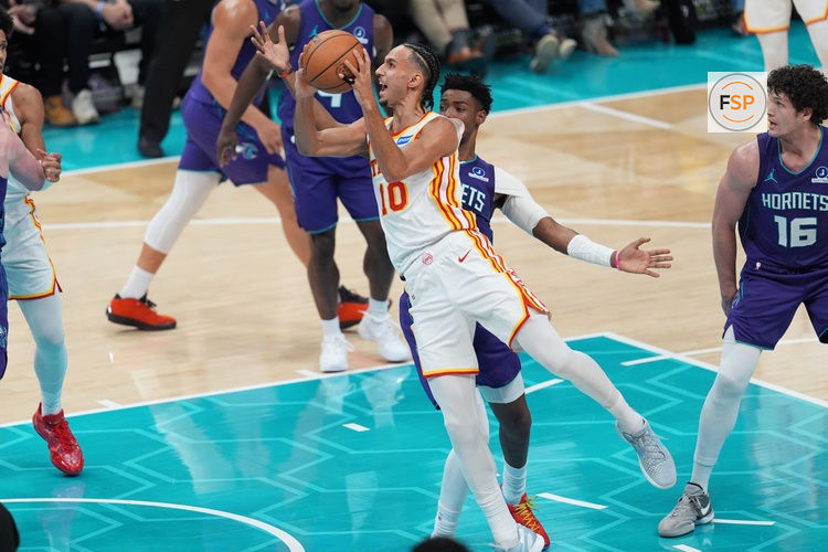 Feb 11, 2026; Charlotte, North Carolina, USA; Atlanta Hawks forward Zaccharie Risacher (10) shoots off balance guarded by Charlotte Hornets forward Brandon Miller (24) during second quarter at Spectrum Center. Credit: Jim Dedmon-Imagn Images
