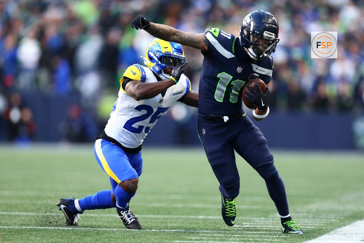 Jan 25, 2026; Seattle, WA, USA; Seattle Seahawks wide receiver Jaxon Smith-Njigba (11) runs against Los Angeles Rams cornerback Roger McCreary (25) during the first half in the 2026 NFC Championship Game at Lumen Field. Credit: Kevin Ng-Imagn Images