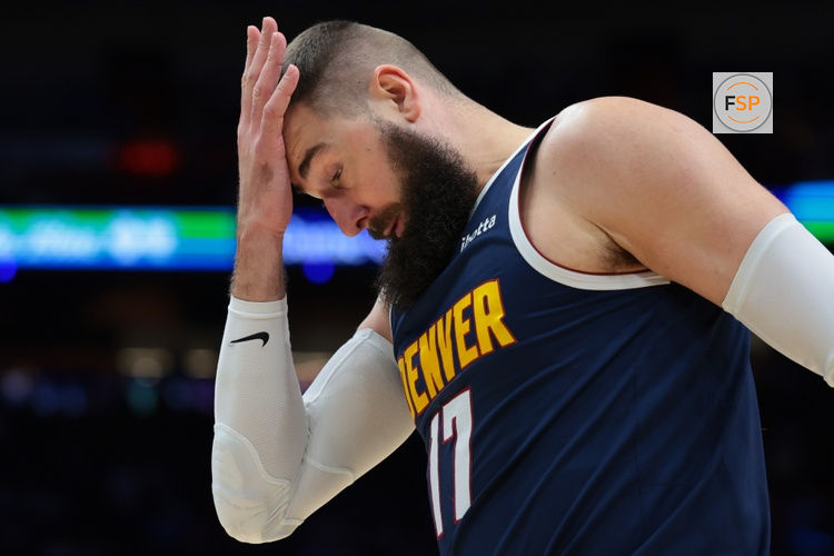 Dec 29, 2025; Miami, Florida, USA; Denver Nuggets center Jonas Valanciunas (17) covers his forehead with his hand after driving to the basket against the Miami Heat during the second quarter at Kaseya Center. Credit: Sam Navarro-Imagn Images