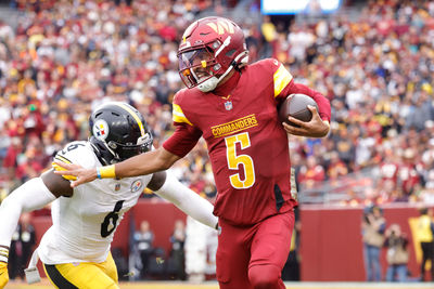 Nov 10, 2024; Landover, Maryland, USA; Washington Commanders quarterback Jayden Daniels (5) carries the ball as Pittsburgh Steelers linebacker Patrick Queen (6) defends during the first half at Northwest Stadium. Mandatory Credit: Amber Searls-Imagn Images