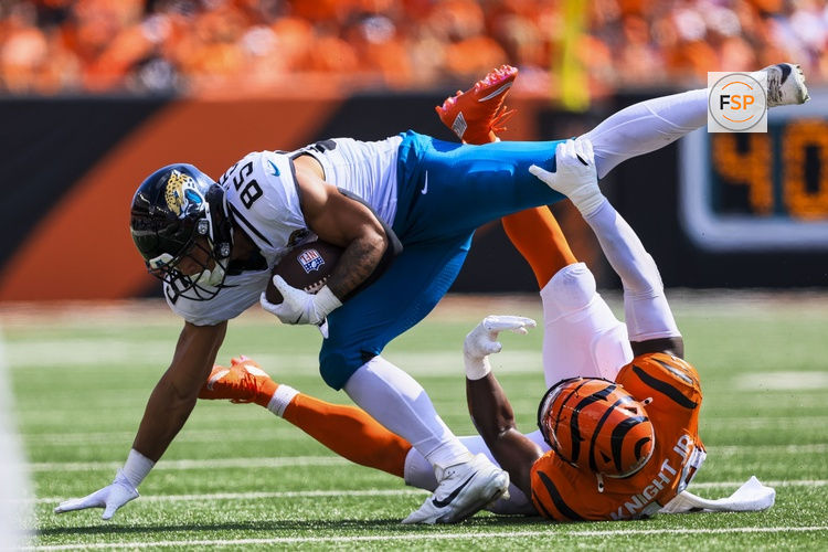 Sep 14, 2025; Cincinnati, Ohio, USA; Cincinnati Bengals linebacker Demetrius Knight Jr. (44) brings down Jacksonville Jaguars tight end Brenton Strange (85) in the second half at Paycor Stadium. Credit: Katie Stratman-Imagn Images