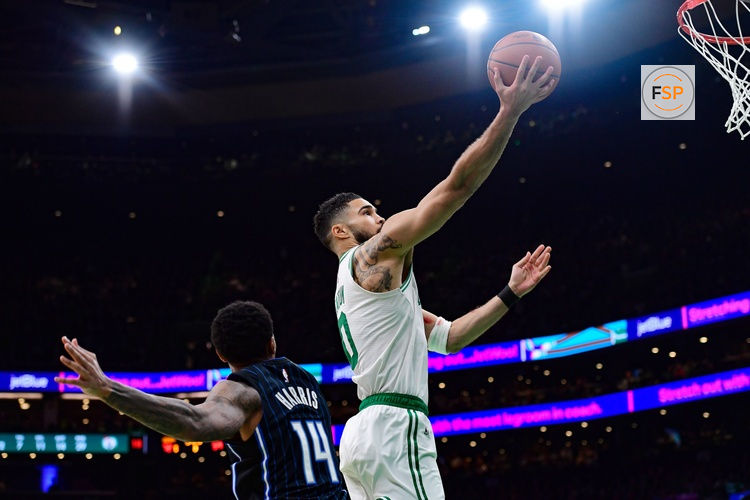 Apr 20, 2025; Boston, Massachusetts, USA; Boston Celtics forward Jayson Tatum (0) drives to the basket past Orlando Magic guard Gary Harris (14) during the second half at TD Garden. Credit: Bob DeChiara-Imagn Images