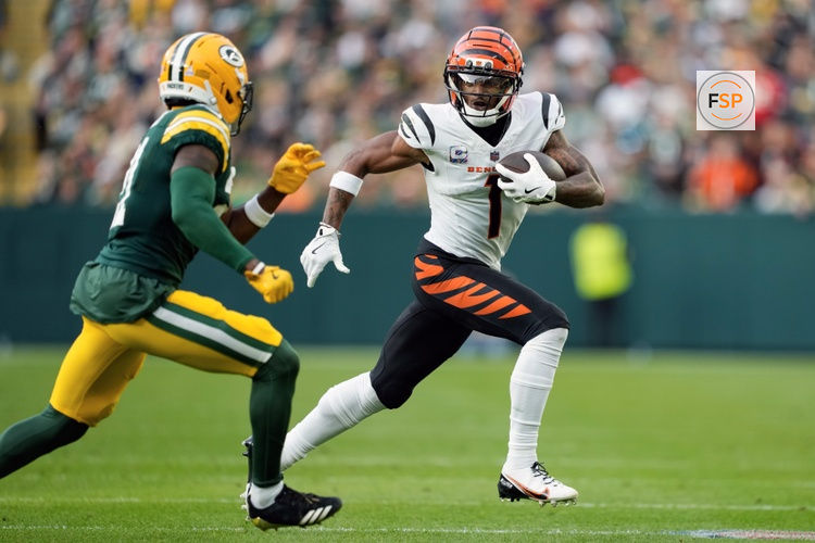 Oct 12, 2025; Green Bay, Wisconsin, USA;  Cincinnati Bengals wide receiver Ja'Marr Chase (1) rushes with the football after catching a pass during the third quarter against the Green Bay Packers at Lambeau Field. Credit: Jeff Hanisch-Imagn Images