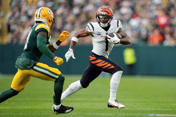 Oct 12, 2025; Green Bay, Wisconsin, USA;  Cincinnati Bengals wide receiver Ja'Marr Chase (1) rushes with the football after catching a pass during the third quarter against the Green Bay Packers at Lambeau Field. Mandatory Credit: Jeff Hanisch-Imagn Images