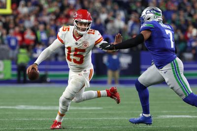 Oct 25, 2026; Seattle, Washington, USA;  Kansas City Chiefs quarterback Patrick Mahomes (15) scrambles with the ball under pressure from Seattle Seahawks linebacker Uchenna Nwosu (7) during the third quarter at Lumen Field.  Mandatory Credit: Joe Nicholson-Imagn Images