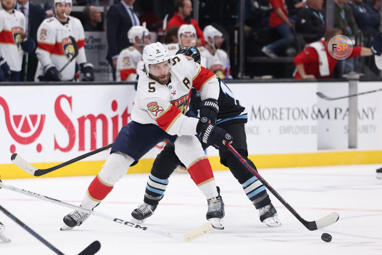 Jan 8, 2025; Salt Lake City, Utah, USA; Florida Panthers defenseman Aaron Ekblad (5) passes the puck against the Utah Hockey Club during the first period at Delta Center. Credit: Rob Gray-Imagn Images