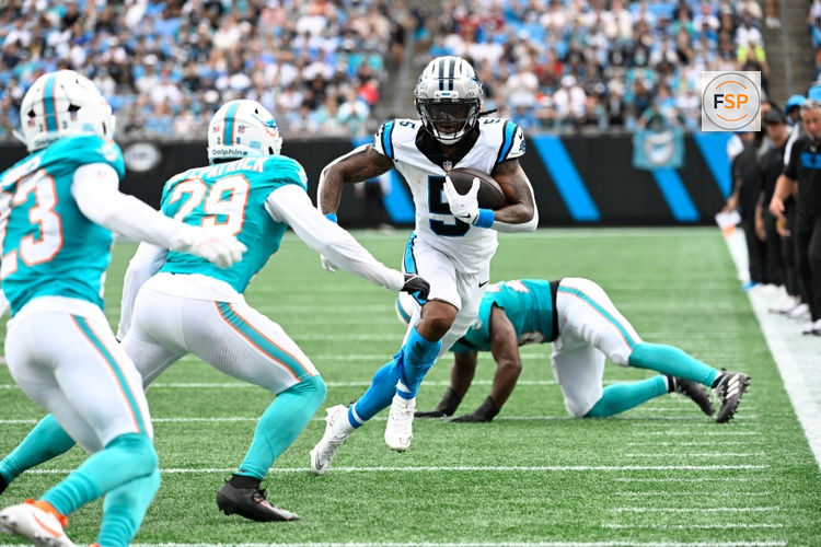 Oct 5, 2025; Charlotte, North Carolina, USA; Carolina Panthers running back Rico Dowdle (5) with the ball as Miami Dolphins free safety Minkah Fitzpatrick (29) defends in the second quarter at Bank of America Stadium. Credit: Bob Donnan-Imagn Images